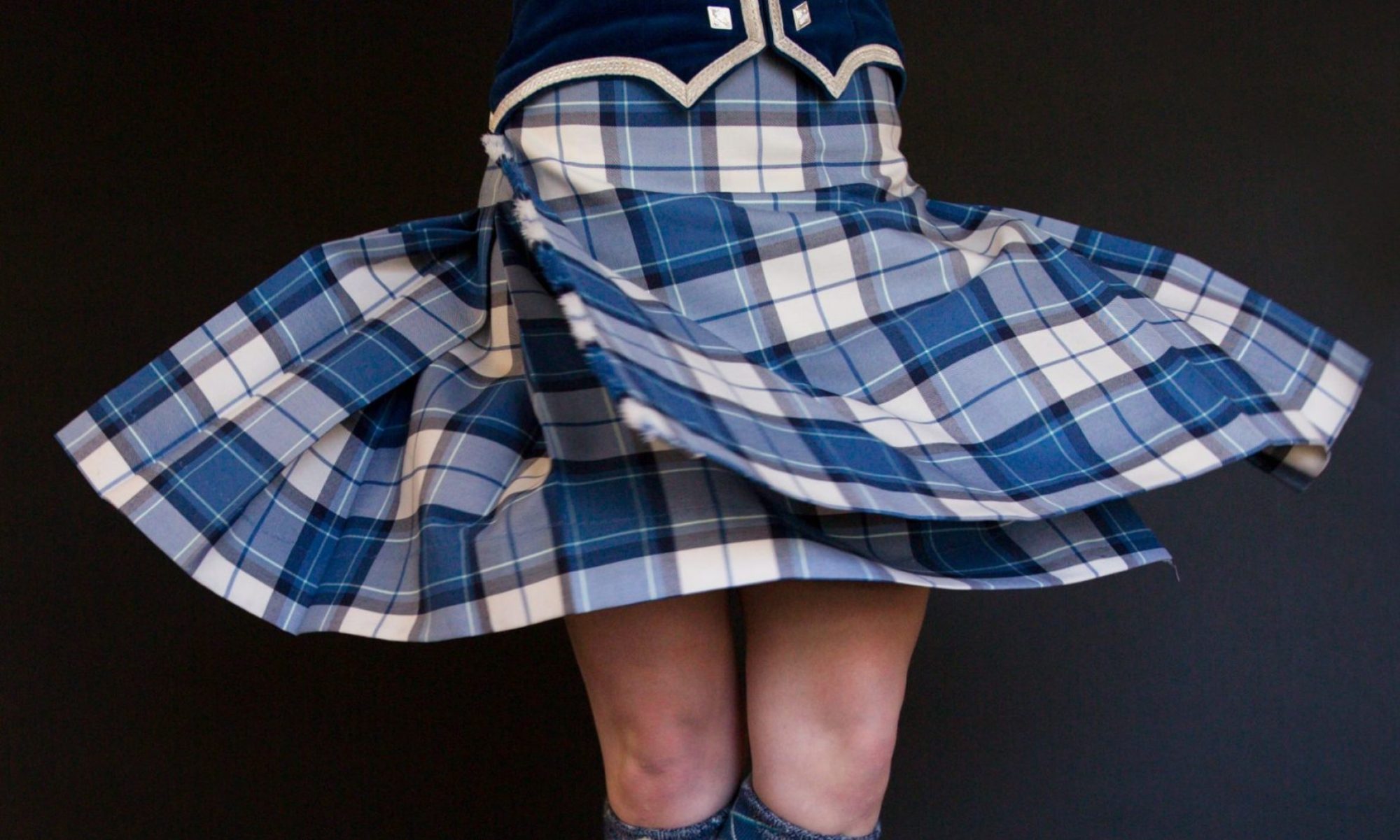 Highland Dancer spinning in tartan